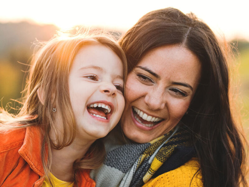 Mother and daughter sharing a joyful moment together outdoors